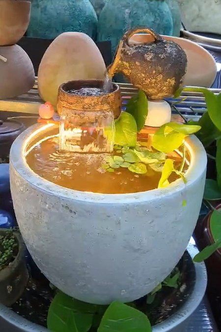 ✨ نافورة حجرية بفوهة فخارية وإضاءة دافئة